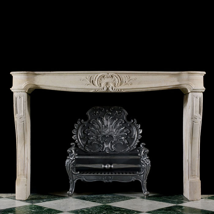 A Louis XIV Baroque Limestone Chimneypiece 
