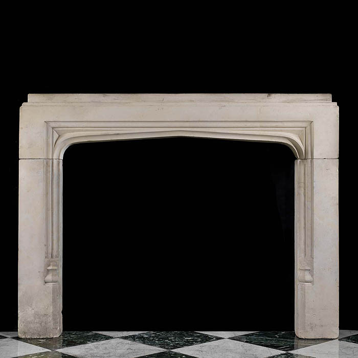 An antique Tudor style limestone fireplace surround 