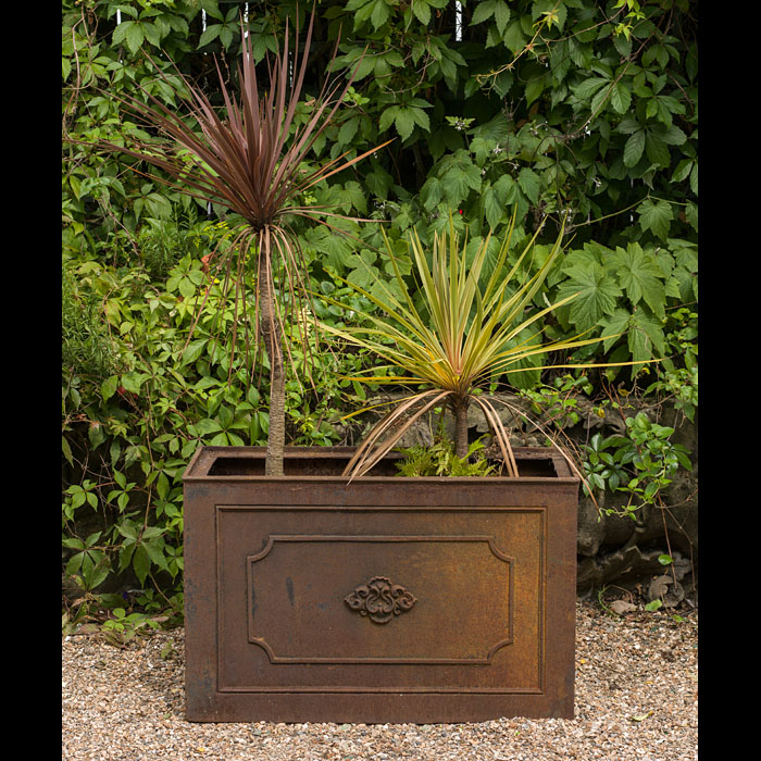 A large antique cast iron garden planter.