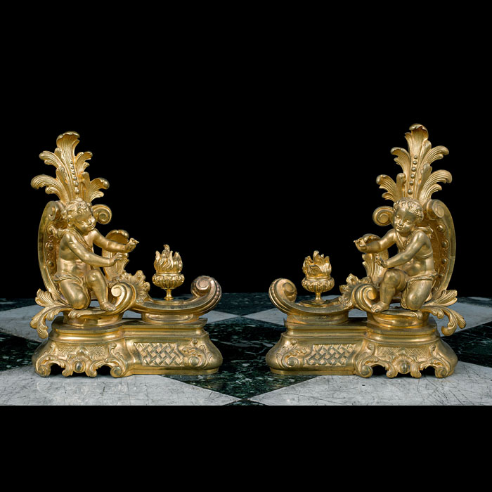 A pair of Rococo style cherubic gilt bronze antique chenet 