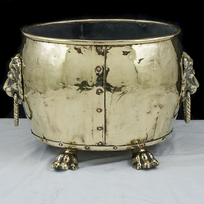 An Edwardian brass lion mask log bin    