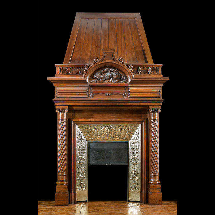 A Renaissance style columned, carved Walnut trumeau fireplace.