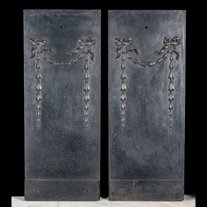 A cast iron pair of bellflower fireplace inserts    