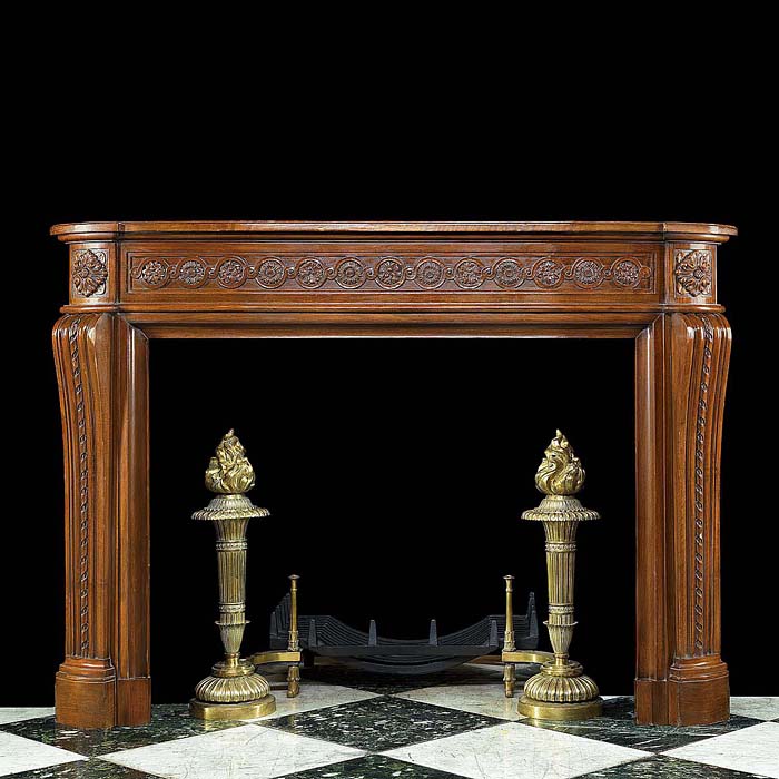 A Carved Walnut Louis XVI Chimneypiece

