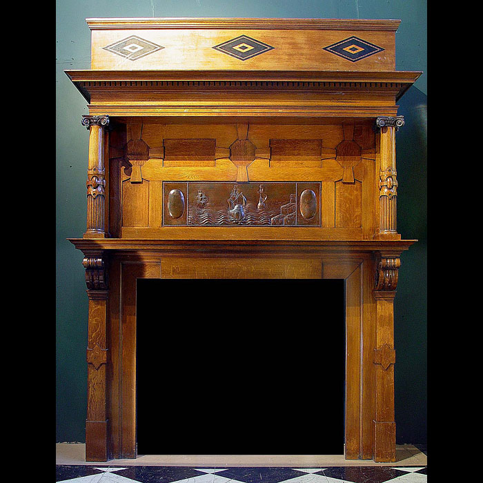 An antique Arts & Crafts oak inlaid fireplace surround   